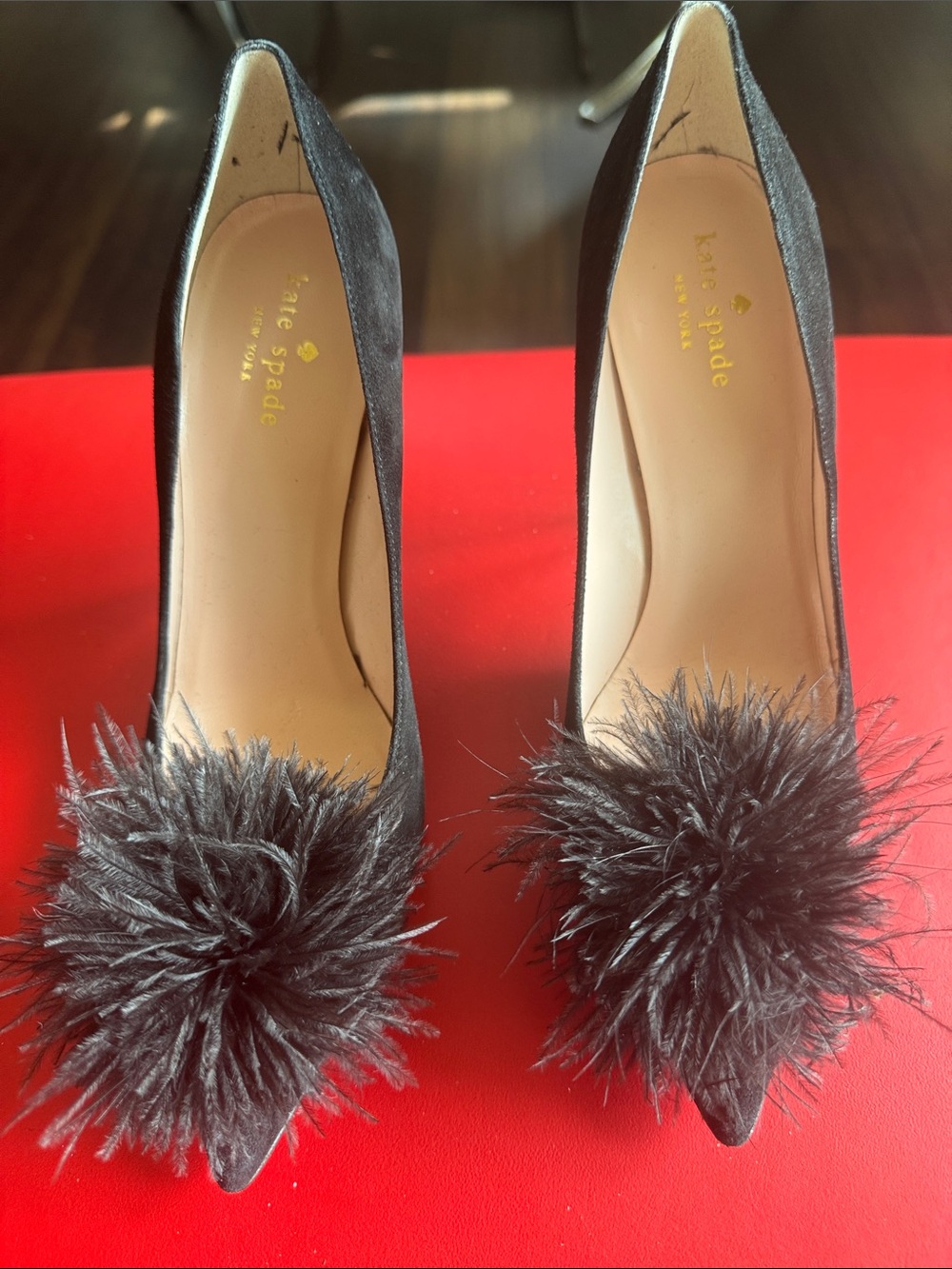kate spade black pointed-toe pumps with feather pom accents